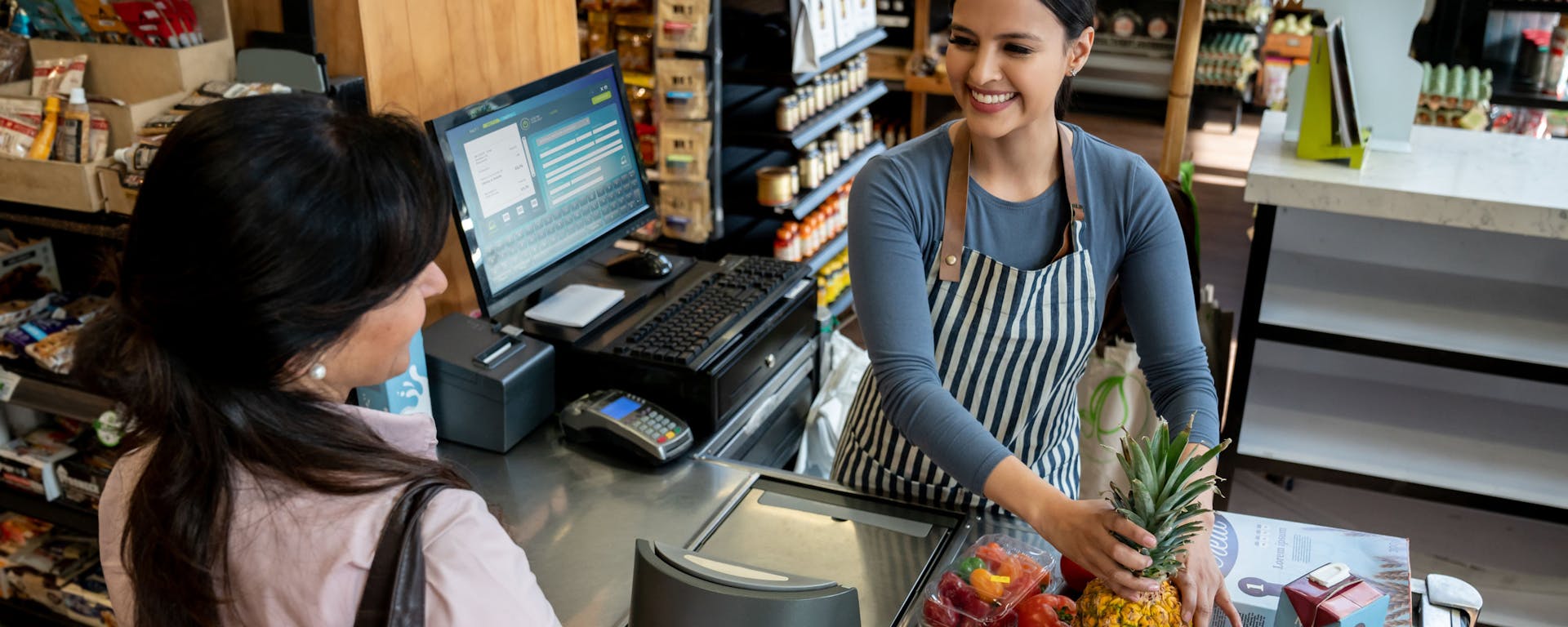 A woman checking out at a grocery store.