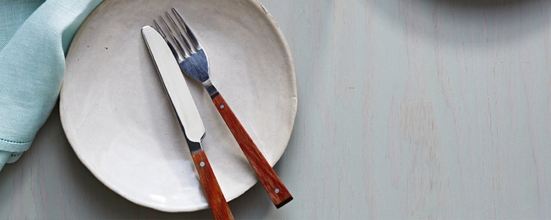 An empty plate with a fork and knife.