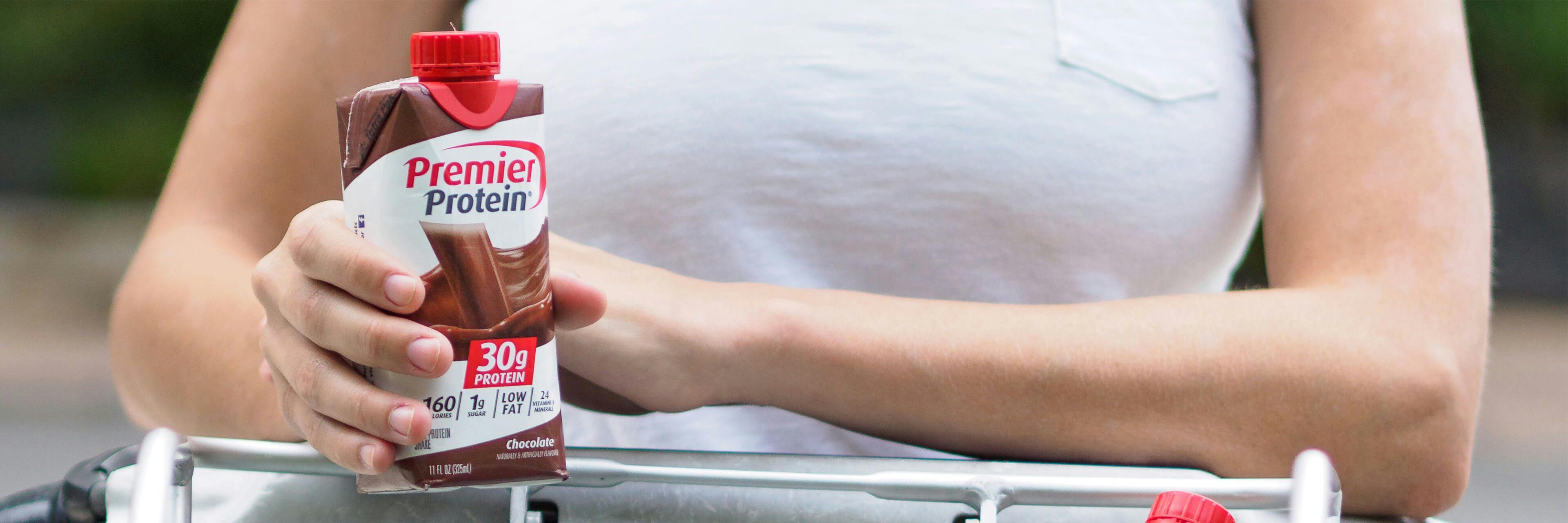A person enjoying a chocolate Premier Protein shake.