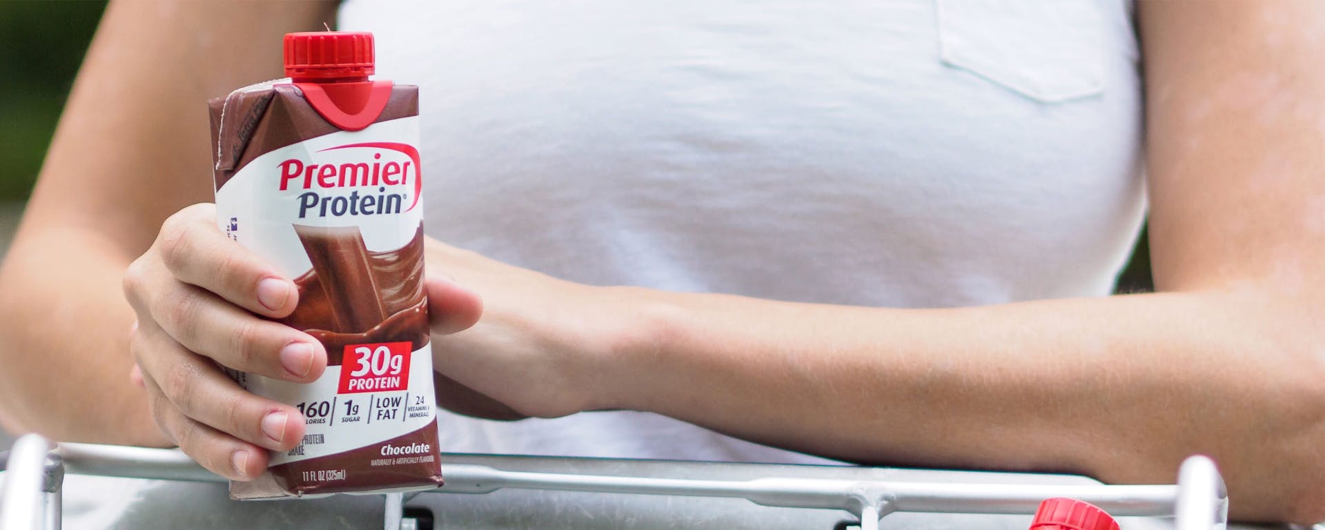 A person enjoying a chocolate Premier Protein shake.