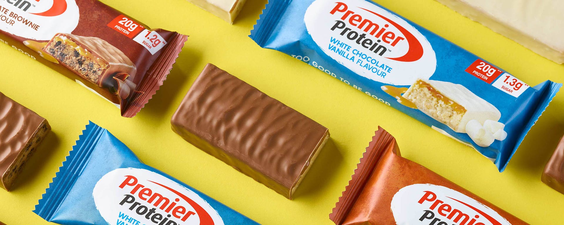 A number of wrapped and unwrapped Premier Protein bars.