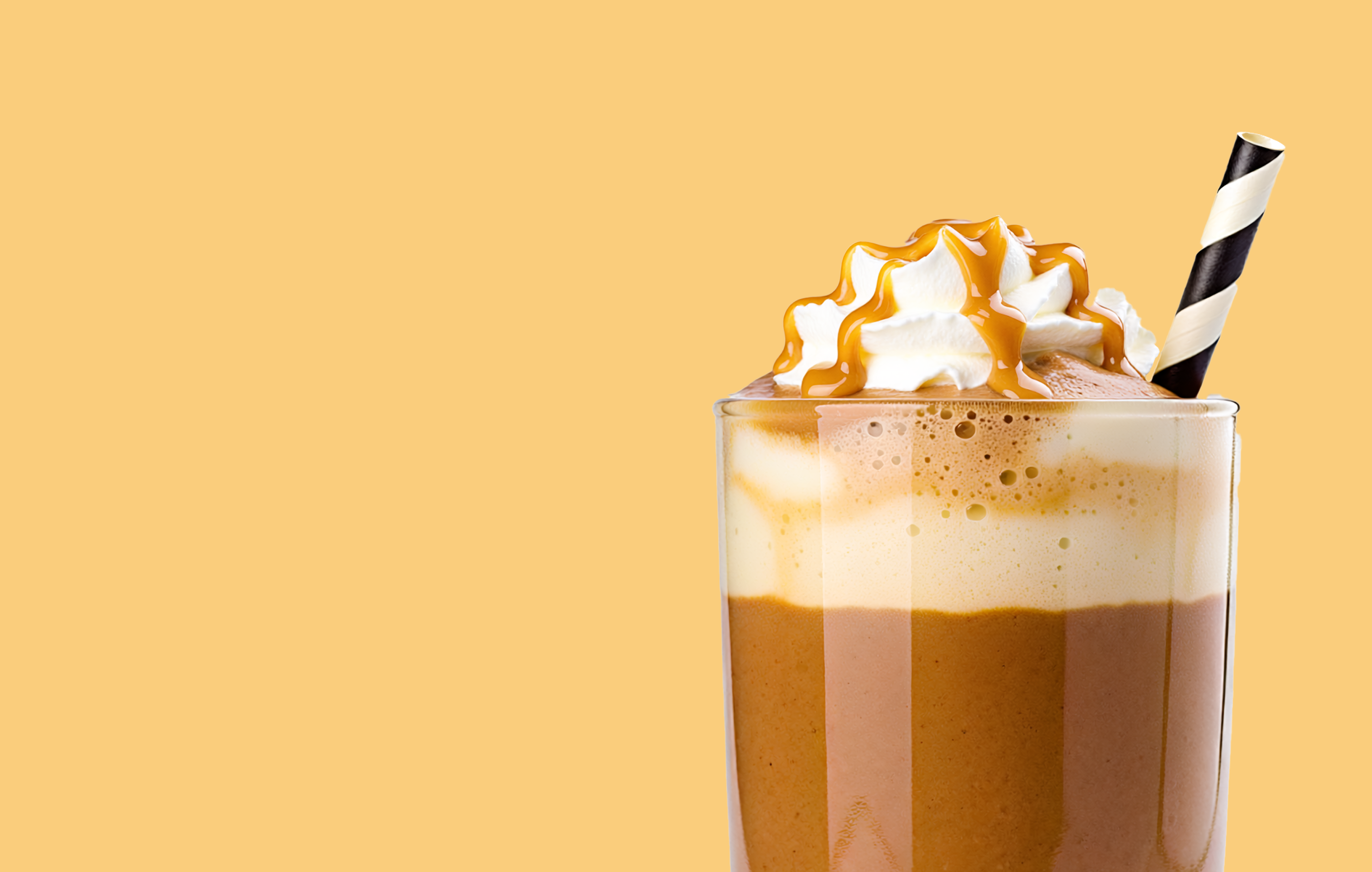 A large glass filled with a coffee banana smoothie made with Premier Protein.
